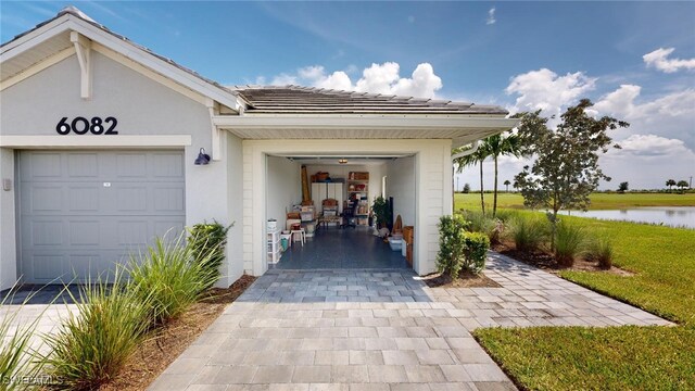 6082 National Blvd Unit 128, Ave Maria, FL 34142 - doorway to property with a garage and a water view