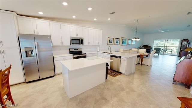 6082 National Blvd Unit 128, Ave Maria, FL 34142 - kitchen featuring sink, decorative light fixtures, a center island, appliances with stainless steel finishes, and kitchen peninsula