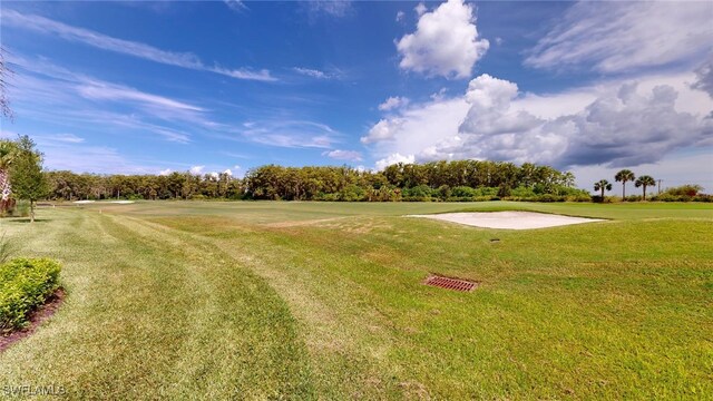 6082 National Blvd Unit 128, Ave Maria, FL 34142 - view of community featuring a lawn
