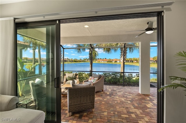 interior space featuring a water view, a wealth of natural light, and ceiling fan