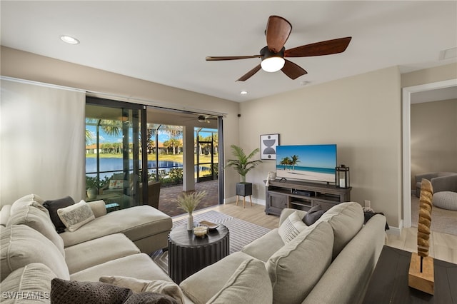 living room featuring ceiling fan and wood-type flooring