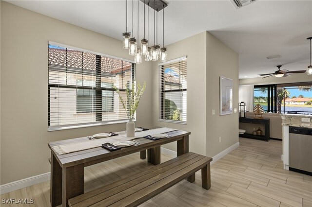 dining room featuring ceiling fan with notable chandelier