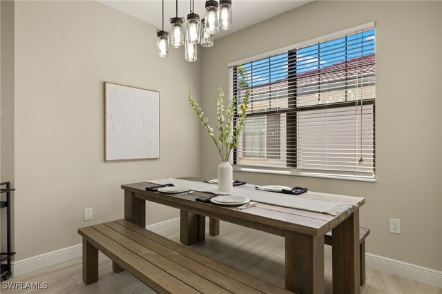 dining area featuring a chandelier and light hardwood / wood-style flooring