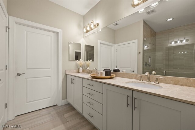 bathroom featuring vanity and a shower with shower door