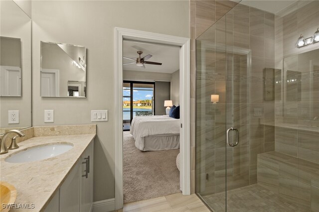 bathroom featuring vanity, a shower with door, and ceiling fan