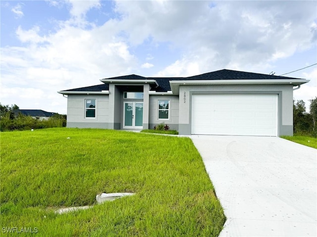 view of front of property featuring a garage and a front yard