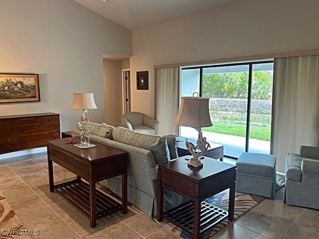 living room featuring high vaulted ceiling