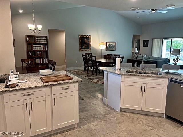 kitchen featuring decorative light fixtures, white cabinetry, dishwasher, sink, and light stone countertops