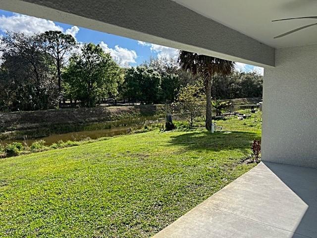 view of yard with a patio and ceiling fan