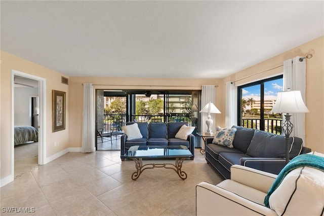 living room featuring light tile patterned flooring and a wealth of natural light