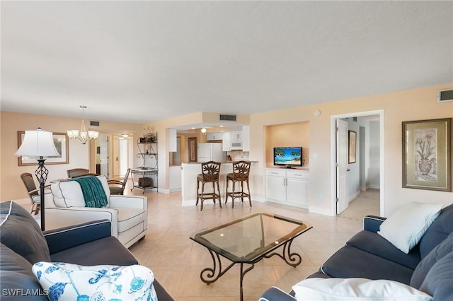 living room featuring light tile patterned flooring and a notable chandelier