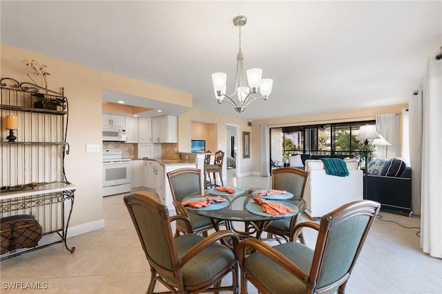 dining room featuring light tile patterned floors and a notable chandelier