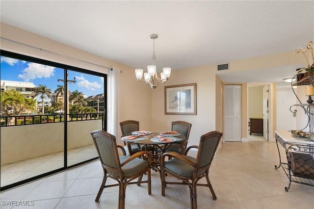 dining area with light tile patterned floors and a notable chandelier