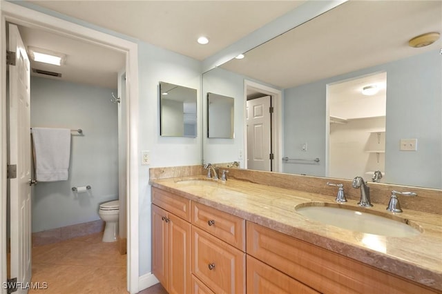 bathroom featuring vanity, toilet, and tile patterned flooring