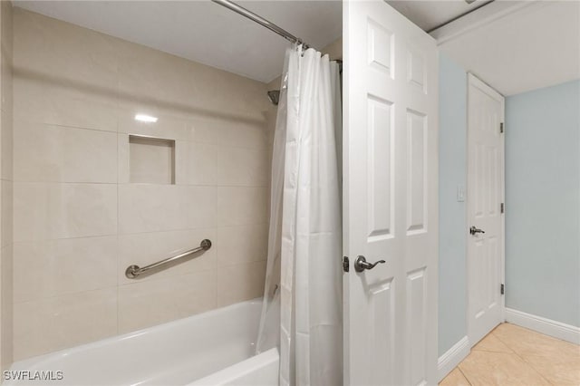 bathroom with shower / bathtub combination with curtain and tile patterned floors