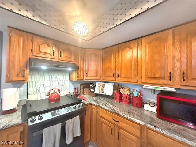 kitchen with dark stone counters and stove