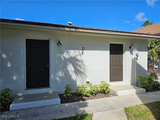 doorway to property with stucco siding