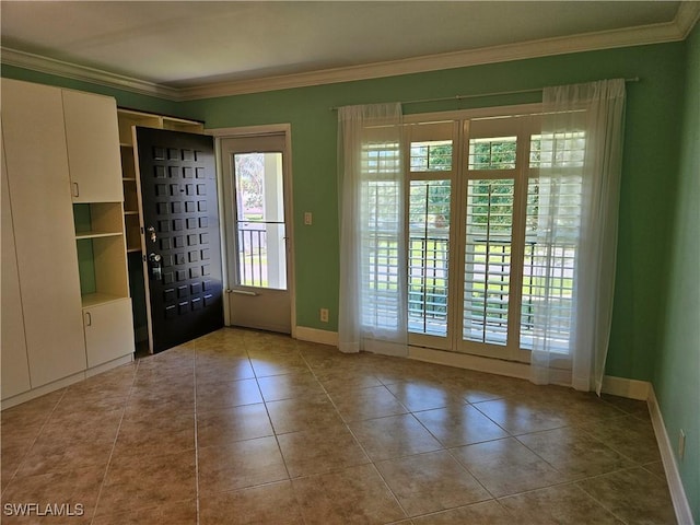 entrance foyer with tile patterned flooring, baseboards, and ornamental molding