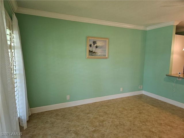 empty room with baseboards, crown molding, and tile patterned flooring