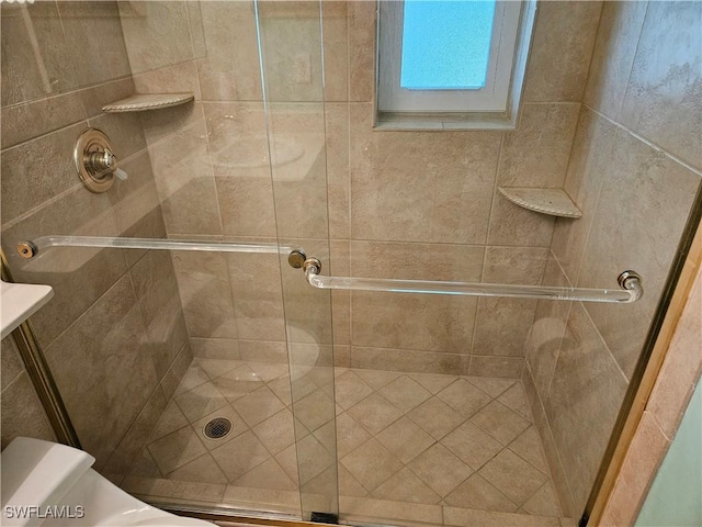 full bathroom with a shower stall and toilet