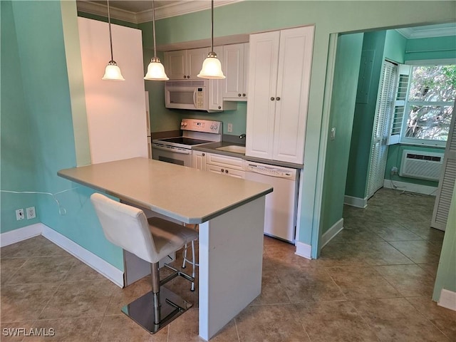 kitchen featuring pendant lighting, white cabinetry, white appliances, a breakfast bar area, and crown molding