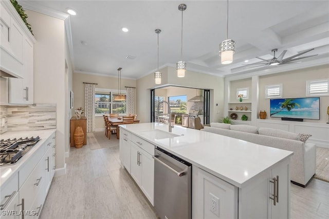 2720 Amaranda Ct, Naples, FL 34114 - kitchen with sink, a center island with sink, pendant lighting, stainless steel appliances, and white cabinets