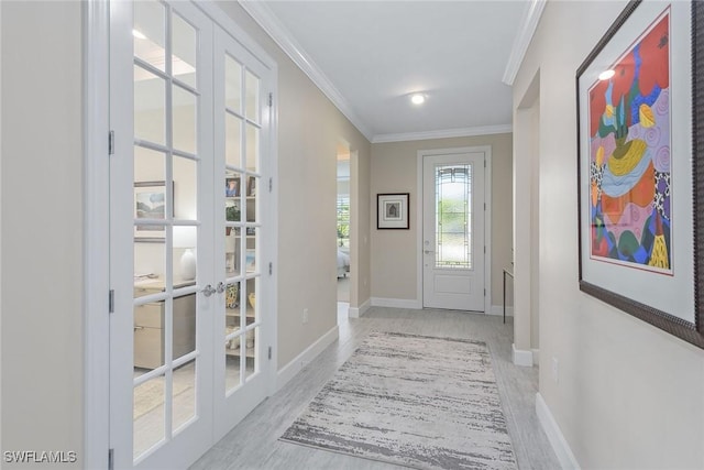 entryway featuring crown molding, light wood-type flooring, and french doors