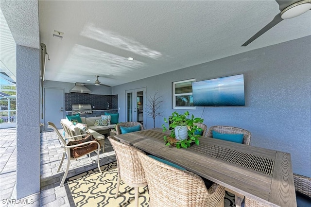 view of patio / terrace with exterior kitchen, ceiling fan, sink, and grilling area