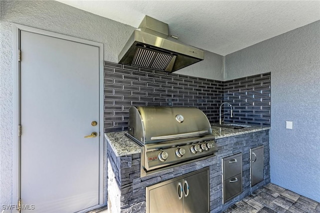 view of patio / terrace with an outdoor kitchen, sink, and grilling area