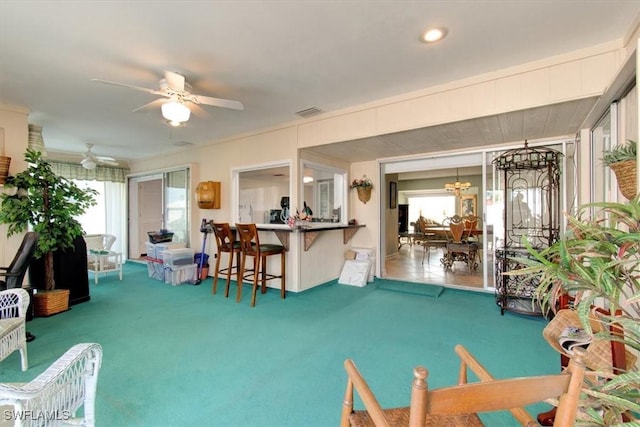 interior space featuring ceiling fan with notable chandelier and visible vents