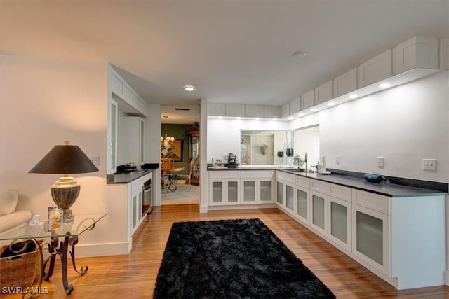 bathroom featuring recessed lighting, wood finished floors, and vanity