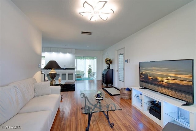 living room with wood finished floors and visible vents