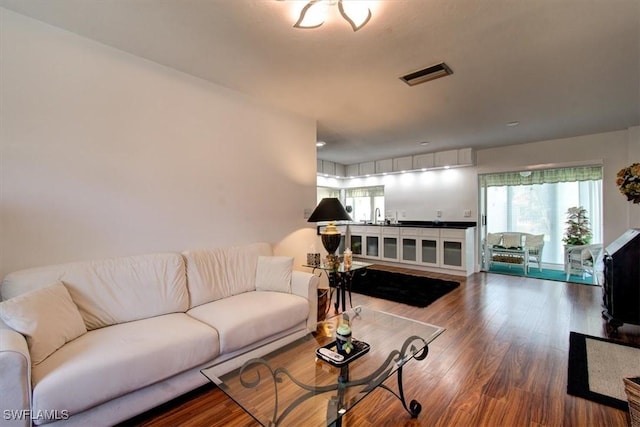 living area featuring wood finished floors and visible vents