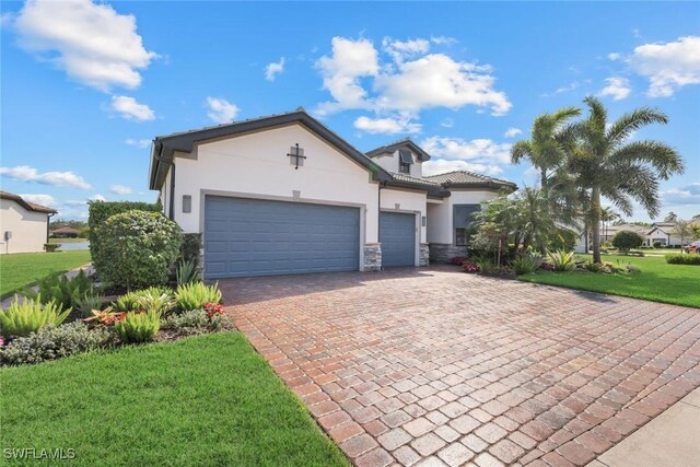 view of front of home with a front lawn and a garage