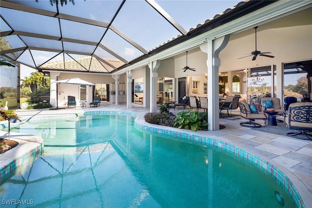 view of pool with ceiling fan, a patio area, and glass enclosure