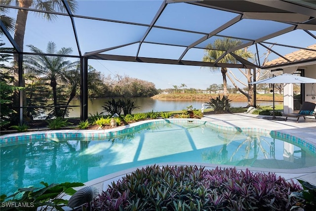 view of swimming pool with a water view, a patio, and glass enclosure