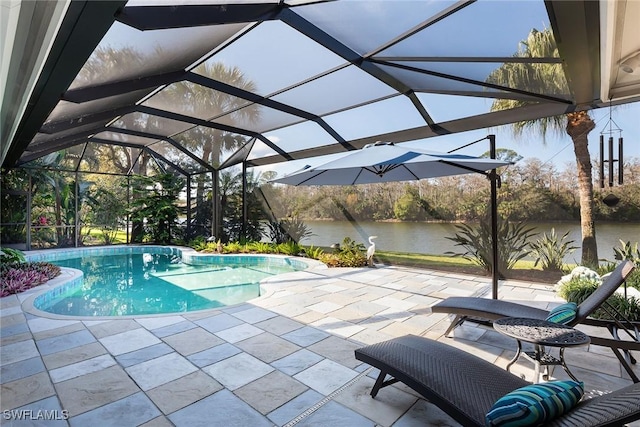 view of pool featuring a lanai, a patio area, and a water view