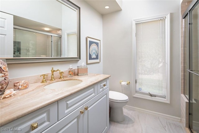 bathroom featuring walk in shower, vanity, and toilet