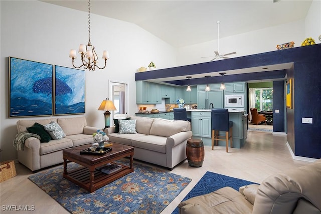 living room featuring ceiling fan with notable chandelier and high vaulted ceiling