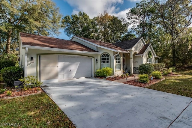 single story home featuring a garage and a front lawn