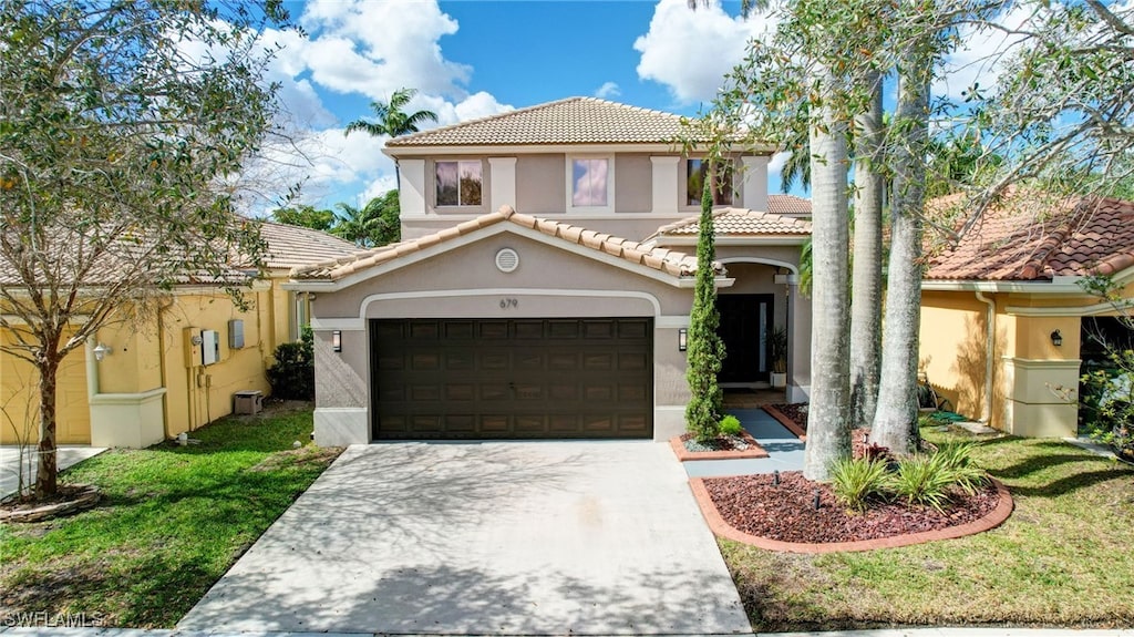 mediterranean / spanish house with a front yard
