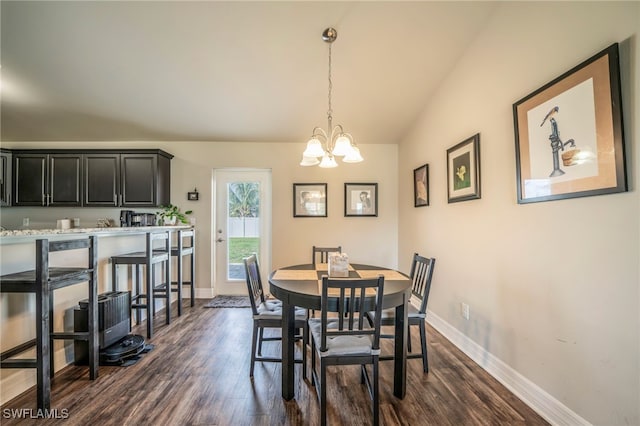 dining space with vaulted ceiling, dark hardwood / wood-style floors, and a notable chandelier