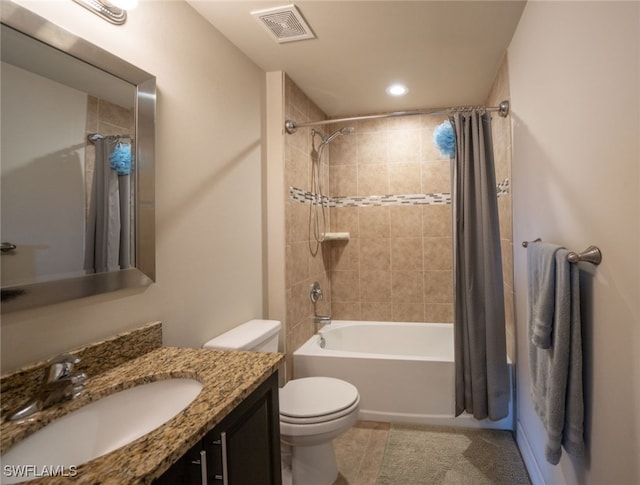 full bathroom featuring vanity, shower / bath combo, tile patterned floors, and toilet