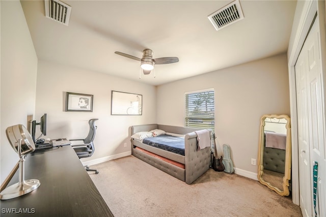 carpeted bedroom with ceiling fan and a closet