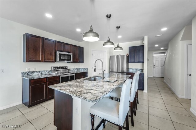 2628 Manzilla Ln, Cape Coral, FL 33909 - kitchen with stainless steel appliances, a sink, light tile patterned floors, baseboards, and recessed lighting