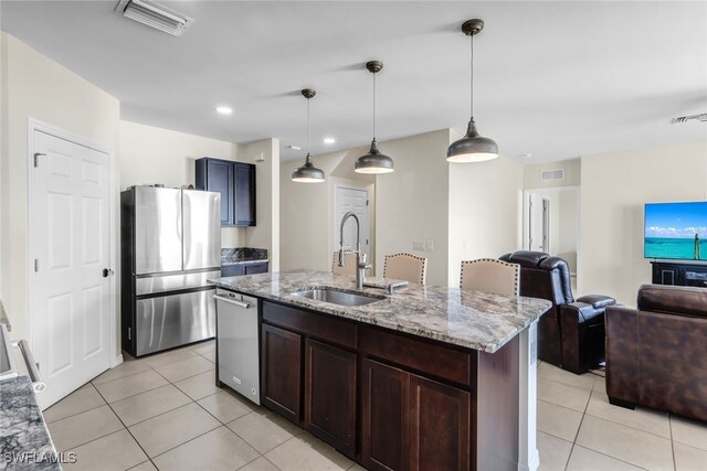 2628 Manzilla Ln, Cape Coral, FL 33909 - kitchen with appliances with stainless steel finishes, a sink, light tile patterned floors, light stone counters, and open floor plan