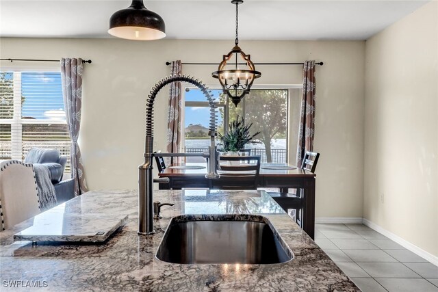 2628 Manzilla Ln, Cape Coral, FL 33909 - dining area featuring tile patterned flooring, a chandelier, and baseboards