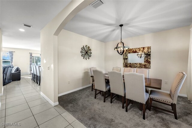 2628 Manzilla Ln, Cape Coral, FL 33909 - carpeted dining area with arched walkways, a chandelier, tile patterned floors, baseboards, and recessed lighting