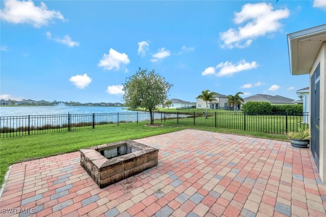 2628 Manzilla Ln, Cape Coral, FL 33909 - view of patio featuring a fire pit, a water view, and a residential view
