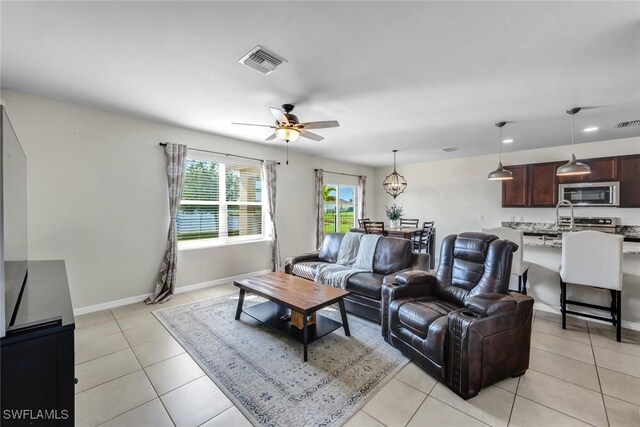 2628 Manzilla Ln, Cape Coral, FL 33909 - living area featuring ceiling fan, light tile patterned flooring, and baseboards